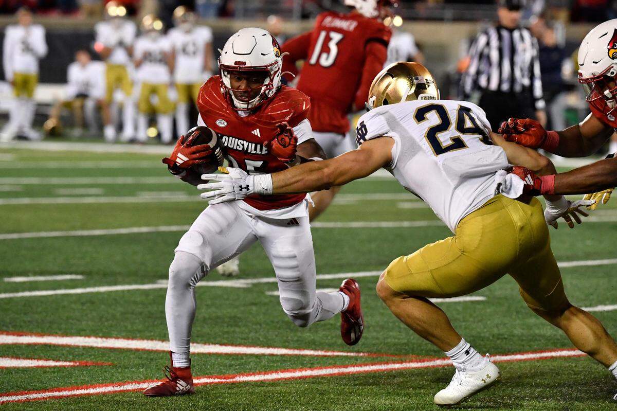 Notre Dame linebacker Jack Kiser (24) attempts to bring down Louisville running back Jawhar Jordan (25) during the second half of an NCAA college football game in Louisville, Ky., Saturday, Oct. 7, 2023. (AP Photo/Timothy D. Easley)