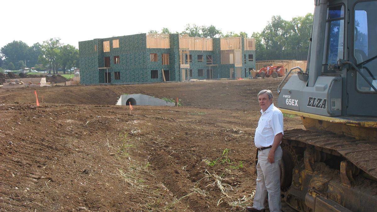 Dennis Anderson, owner of Anderson Communities, checked on one of the remaining lots at his Townley Center development Friday. Under construction nearby are 60 one-bedroom apartments; 88 larger units also will be built.