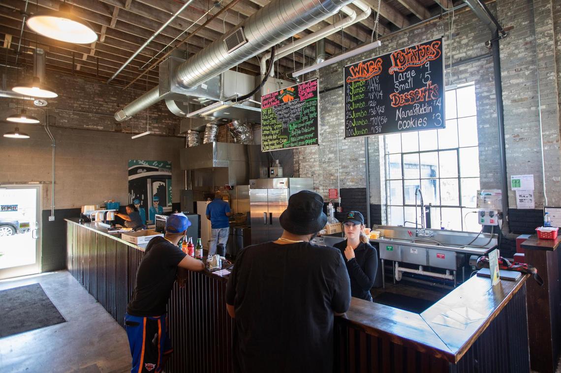 Customers order wings and food at Wing KYng, started by Thomas Williams at Greyline Station in Lexington, Ky., Thursday, May 11, 2023.