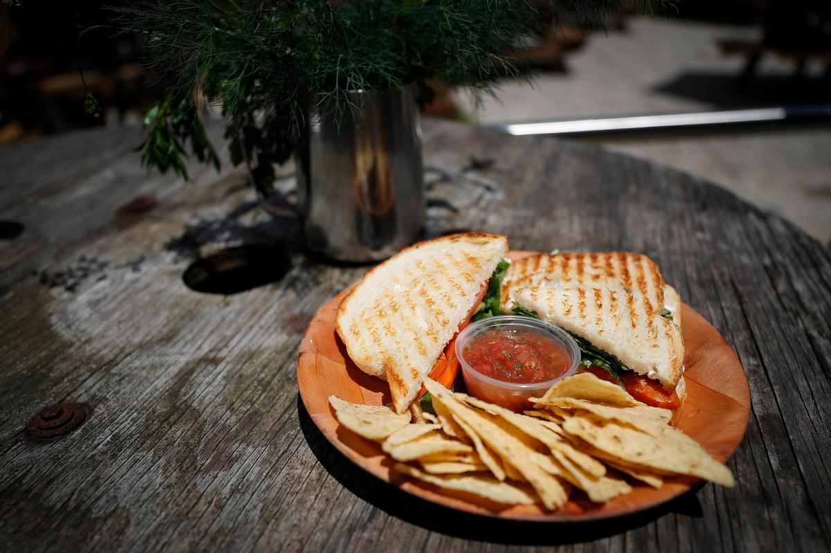 The vegan BLT made with marinated carrot strips, grilled onion, tomato, spinach and vegan mayo on sourdough served with chips and salsa at Broomwagon in Lexington, Ky., Thursday, June 25, 2020.