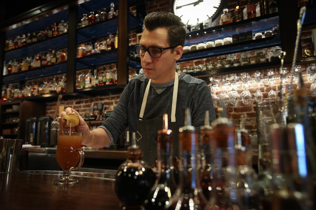 Bartender Jake Sulek garnished a Wassail, one of the holiday cocktails on the menu at West Main Crafting Co. at 135 W. Main St. in Lexington.
