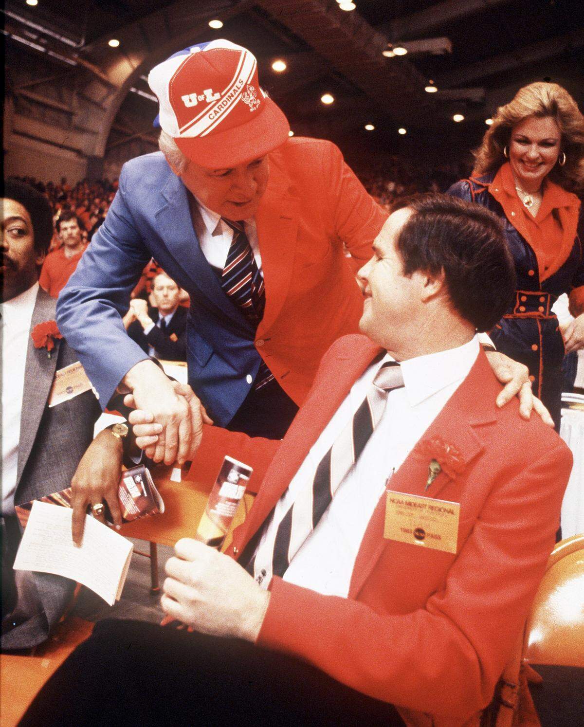 Kentucky governor John Y. Brown, wearing a blue and red sport coat to represent both UK and U of L, greeted Louisville Coach Denny Crum prior to the teams’ meeting in the NCAA Tournament Mideast Regional in Knoxville in 1983. The game was the first Cats-Cards meeting since 1959.