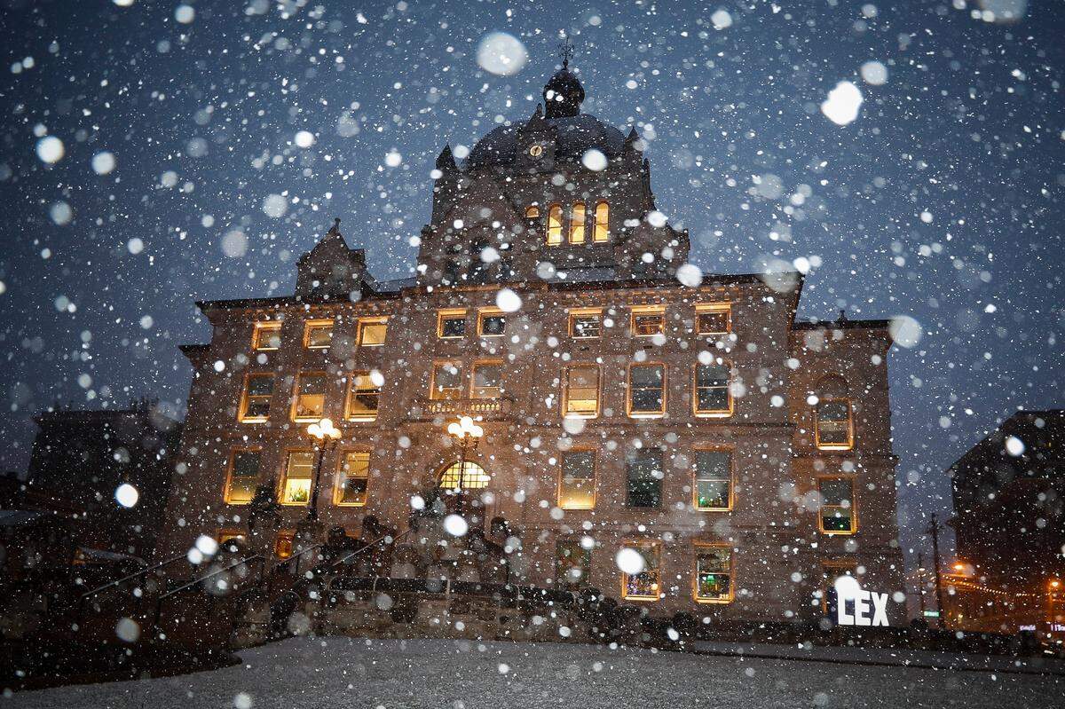 Snow falls around the former Fayette County Courthouse along West Main Street in Lexington, Ky., Wednesday, Jan. 27. 2021. 