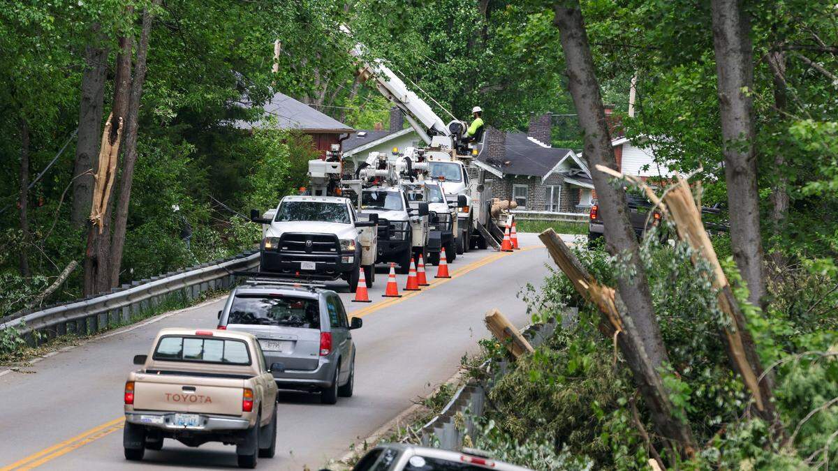 Barbourville Road was down to one lane in front of Slate Hill Baptist Church just outside of London, Ky. in Laurel County Sunday, May 18, 2025 as utility workers made repairs from down lines on the road. Two days earlier, thunderstorms and a deadly tornado ripped through the Southern Kentucky community destroying many homes.
