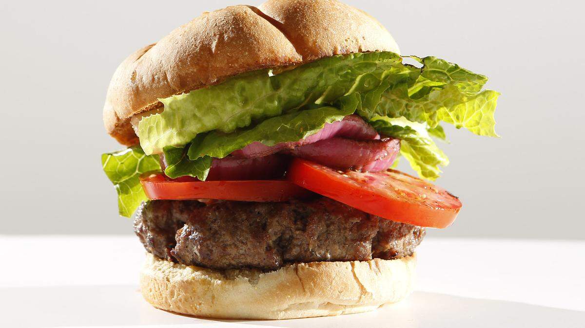 Sirloin burger with buttered and grilled bun, balsamic vinegar caramelized onion slice, lettuce and beautiful perfect bright red tomato slice at Portofino's.