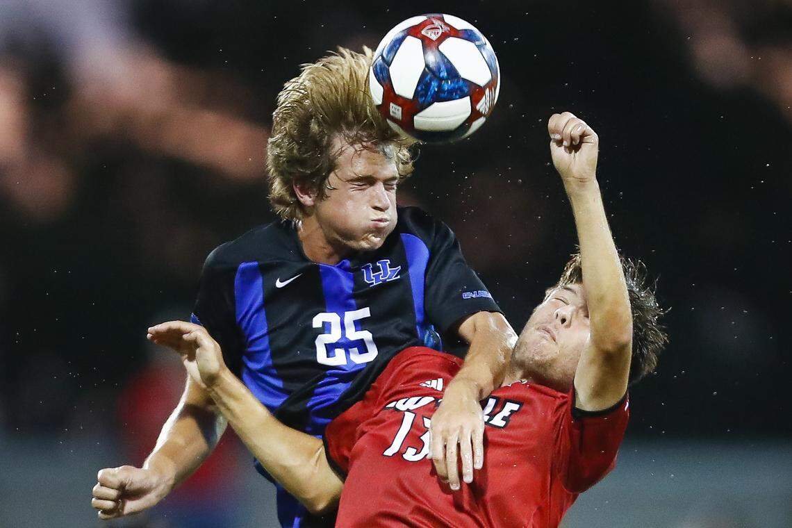 Kentucky Wildcats midfielder Clay Holstad (25) headers the ball past Louisville Cardinals midfielder Bradley Sample (13) during their game at Lynn Stadium in Louisville, Ky., Tuesday, Sept. 3, 2019. Louisville beat Kentucky 3-0.