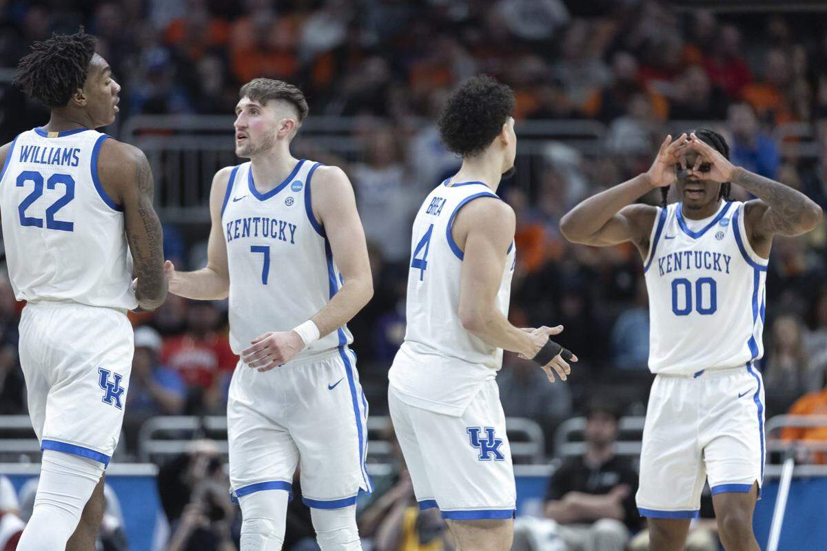 Kentucky center Amari Williams (22), forward Andrew Carr (7), guard Koby Brea (4) and guard Otega Oweh (00) celebrate during their team’s first-round NCAA Tournament victory against Troy at Fiserv Forum in Milwaukee.