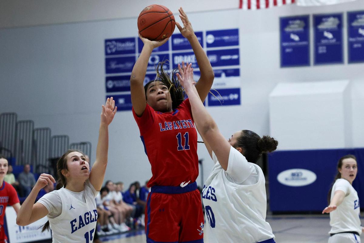 Lafayette’s Isabelle Combs (11) shoots the ball in between Lexington Christian’s Chapel Brown, left, and Jeriko Castle during their game at LCA on Friday.
