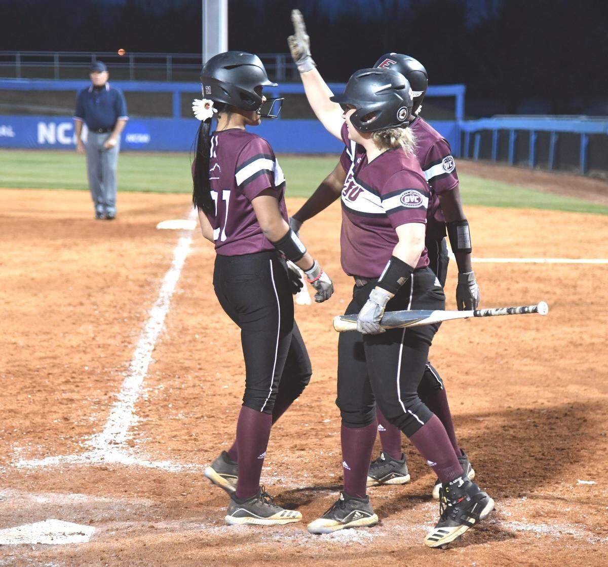 Jaelyn Sanders was greeted at home plate by Eastern Kentucky teammates after hitting a two-run homer in the top of the sixth inning. Sanders hit two home runs and drove in all five EKU runs on Tuesday night.