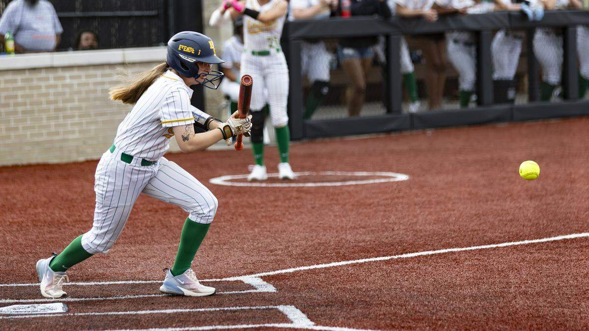 Bryan Station’s Bekah Clark puts down an RBI bunt single during the 11th Region Softball Tournament on Monday at George Rogers Clark High School in Winchester.