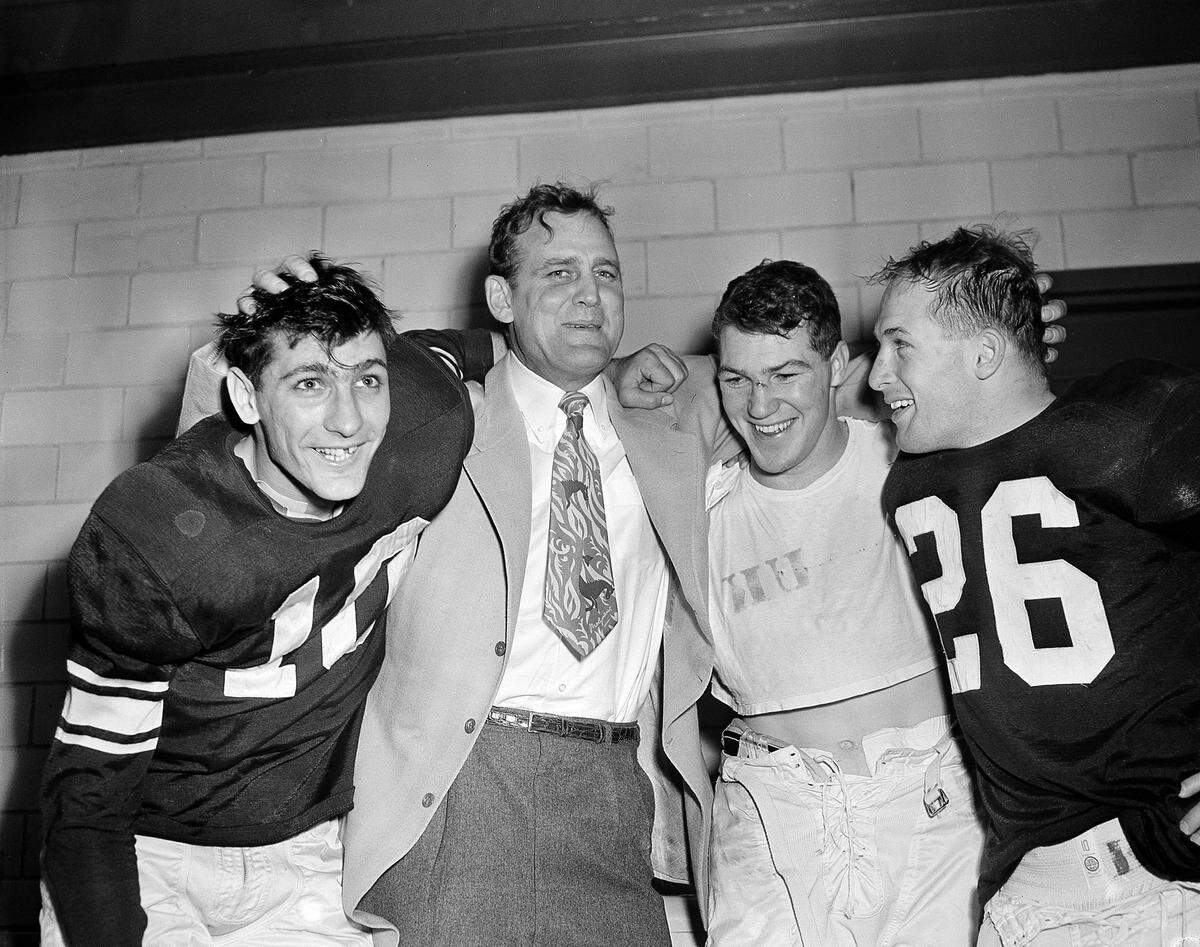 Kentucky Coach Bear Bryant, second from left, celebrated with the three offensive stars of UK’s 20-7 victory over TCU in the 1952 (1951 season) Cotton Bowl. From left, quarterback Babe Parilli; Bryant; running back Ed Hamilton; and end Emery Clark.