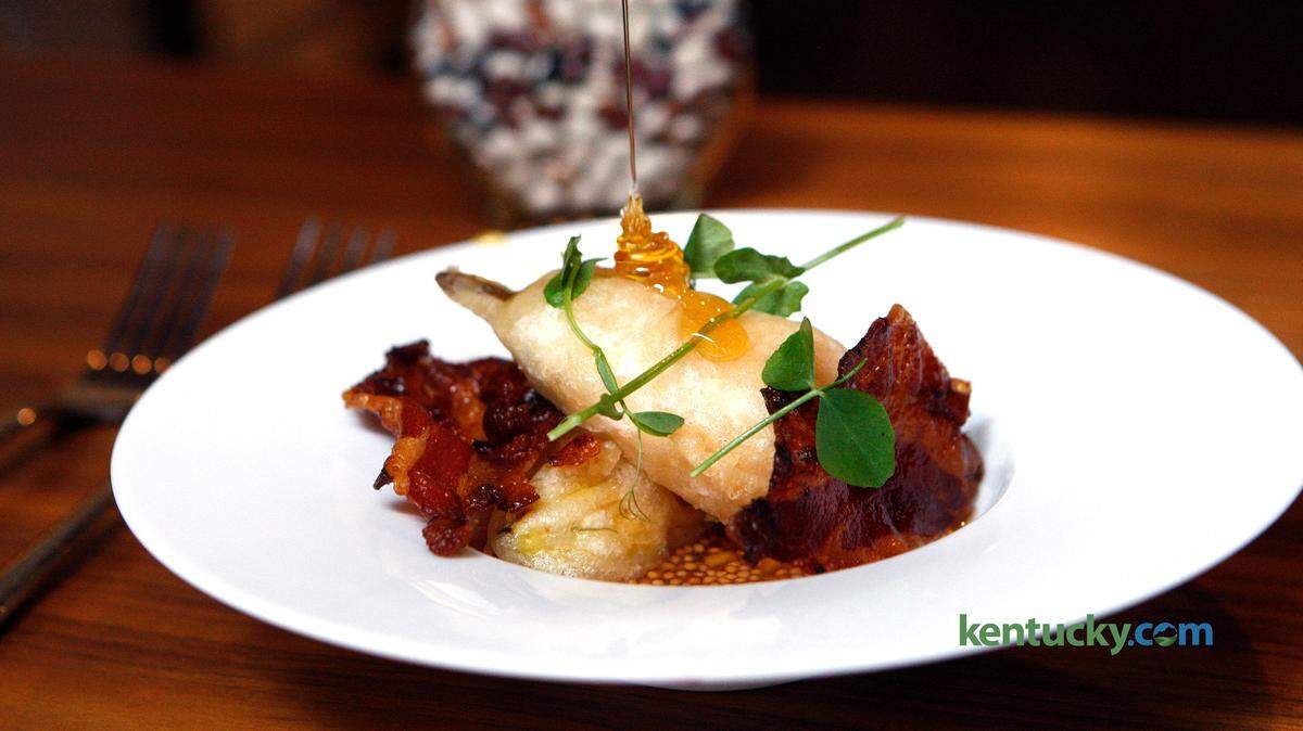 Honey was drizzled over goat cheese squash blossoms with peach mostarda and house Guanciale in 2015 at Distilled.