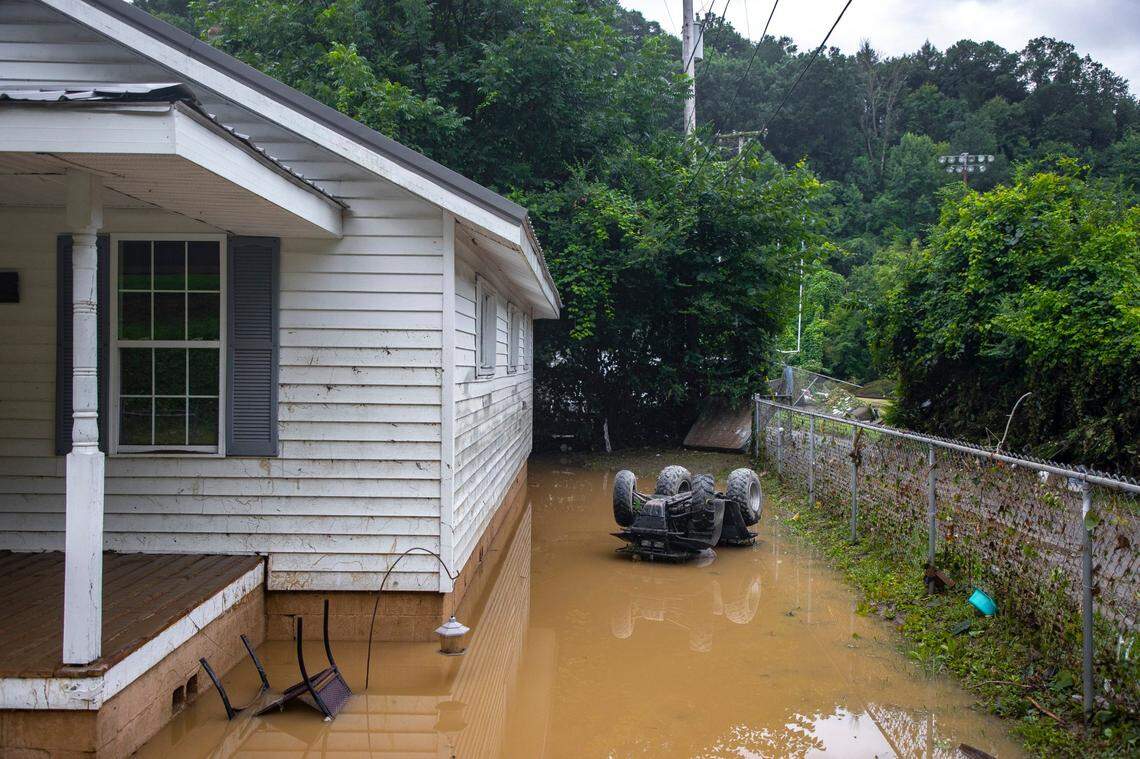 Receding flood waters surround a home in Whitesburg, Ky., on Friday, July 29, 2022.  