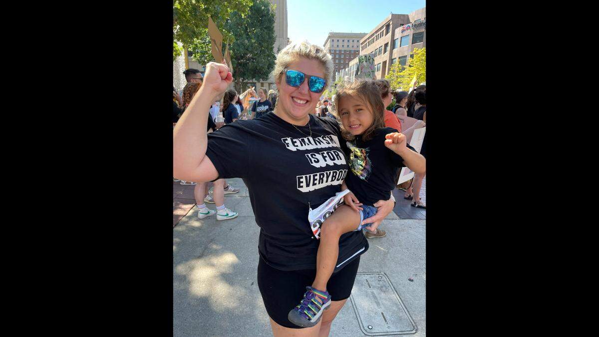 Ryann Alkokar and her daughter, Rena, protest at the Rally for Kentucky Reproductive Rights event on July 4, 2022. Alkokar said it was a “no-brainer” to be there. 