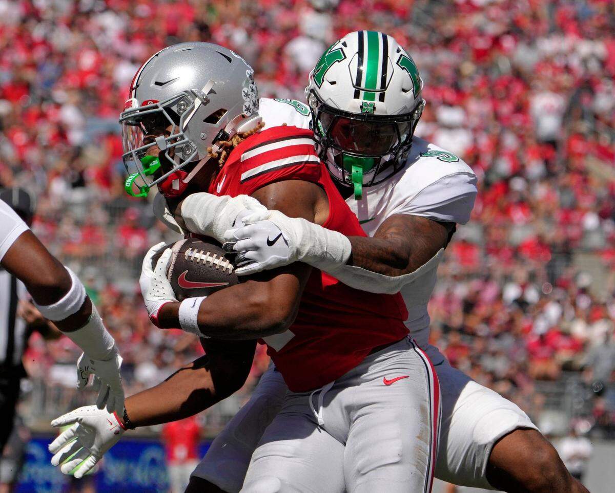 Sept. 21, 2024; Columbus, Ohio, USA;Ohio State Buckeyes running back Quinshon Judkins (1) is tackled by Marshall Thundering Herd linebacker Landyn Watson (9) during the first half of an NCAA Division I football game at Ohio Stadium on Saturday.