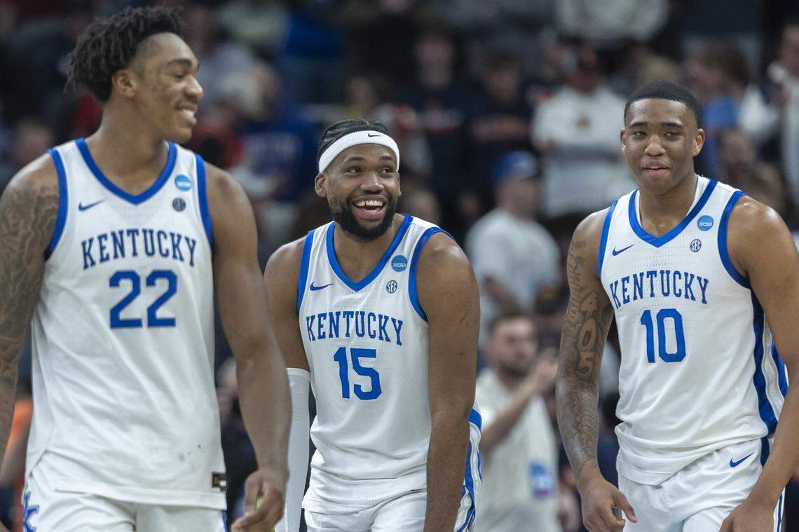 Kentucky forward Ansley Almonor, center, celebrates with Amari Williams, left, and Brandon Garrison after UK’s win over Illinois in the second round of the NCAA Tournament.
