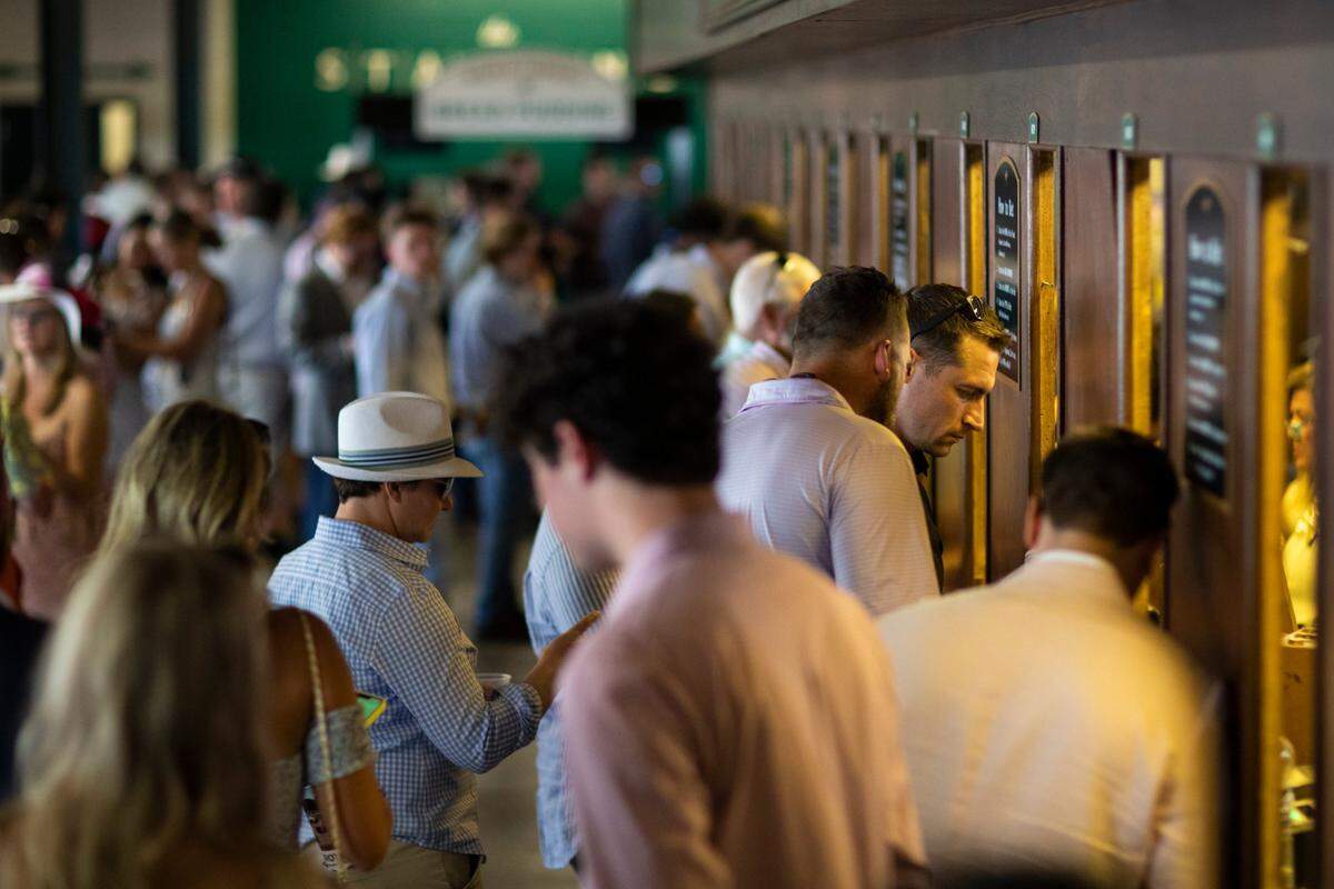 Patrons place bets before races during the Spring Meet at Keeneland on April 15. “I don’t think it’s going to pull money from our handle,” Jim Goodman, director of wagering development at Keeneland, said of legalized sports betting in Kentucky. “I do think it will expose horse racing to a different generation.”