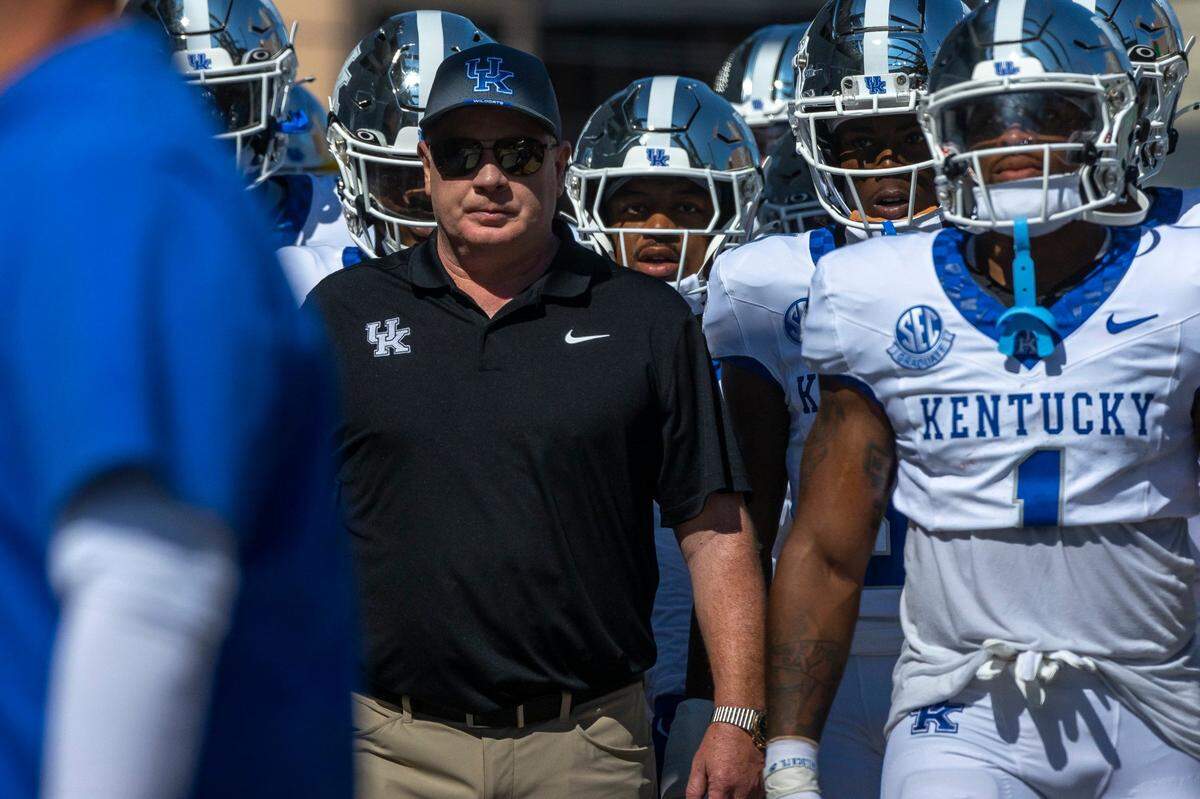 Kentucky head coach Mark Stoops leads his team to the field before Saturday’s game against Vanderbilt.