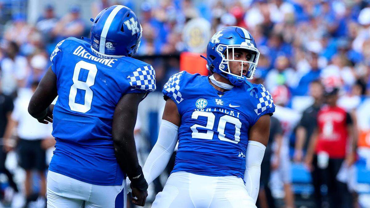 Kentucky linebacker Keaten Wade (20) and defensive tackle Octavious Oxendine celebrate a third-quarter sack on a third-and-10 play against Youngstown State.
