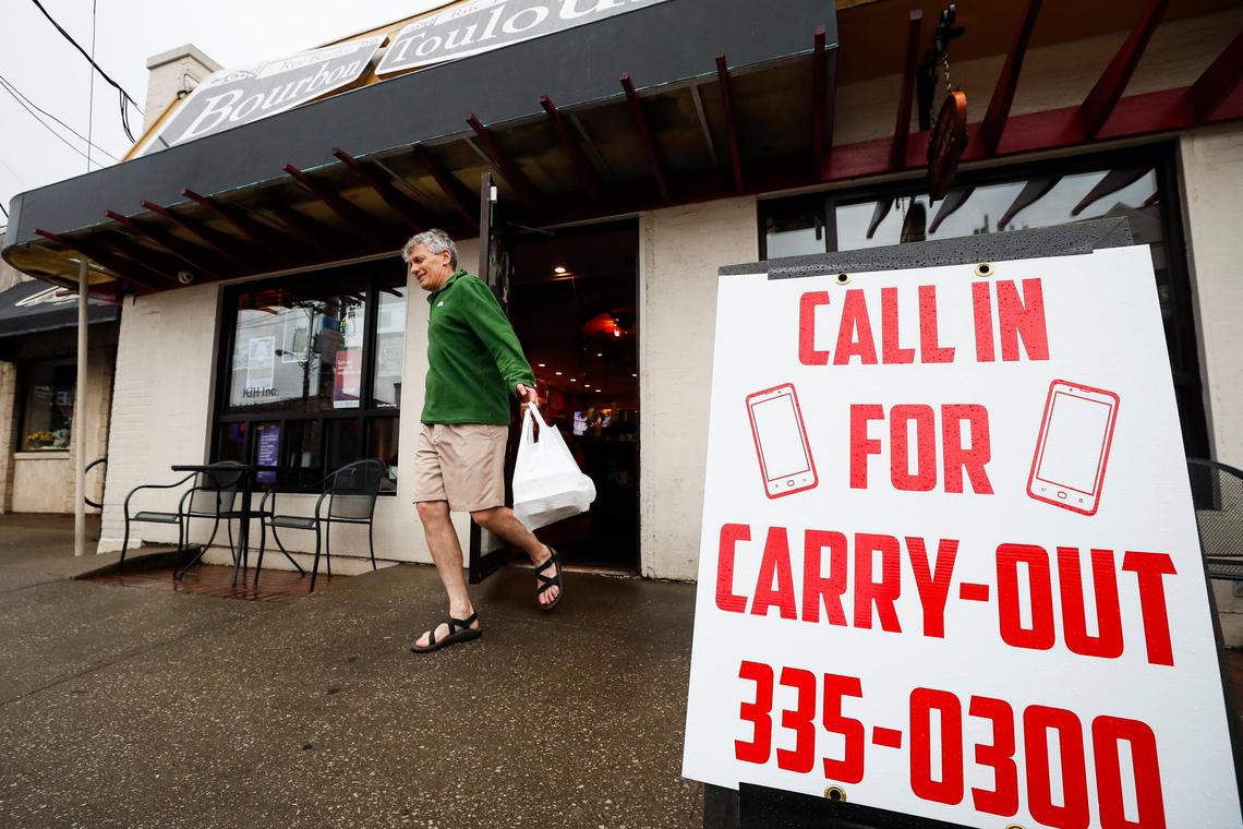 Scott Black leaves with a to-go order Wednesday evening from Bourbon ‘n’ Toulouse in the Chevy Chase neighborhood. Bourbon ‘n’ Toulouse and many other Lexington restaurants are continuing to operate with carryout options.