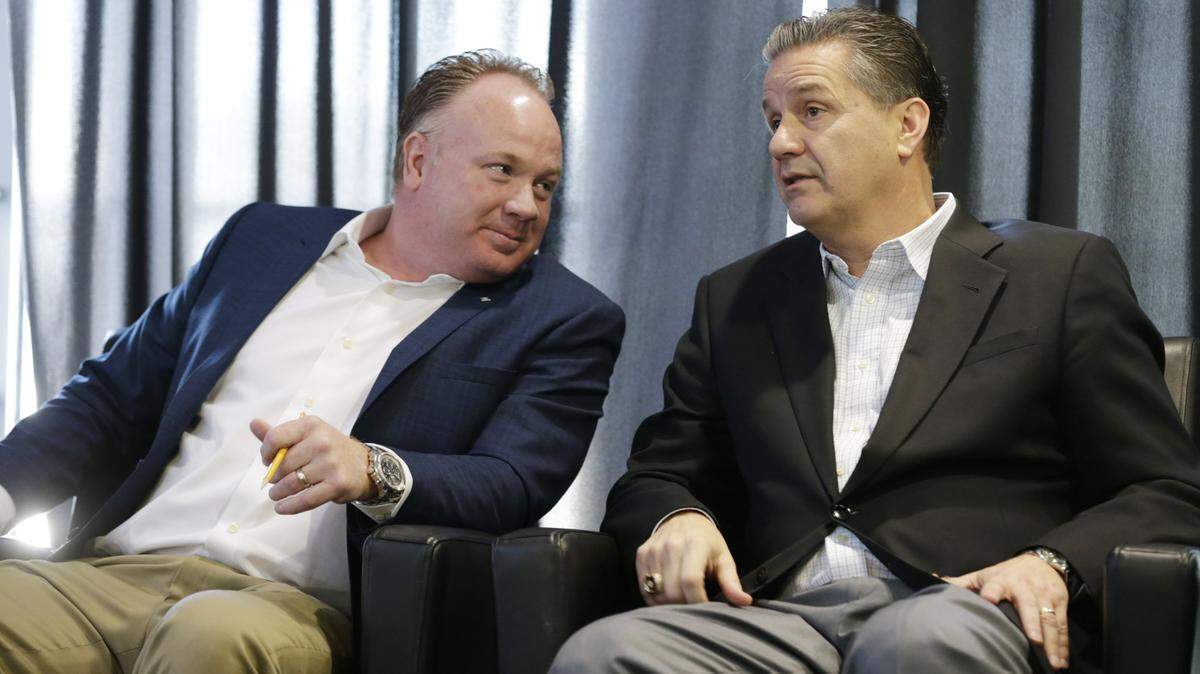 Football coach Mark Stoops and basketball coach John Calipari chat during a UK uniform unveiling event in 2016.