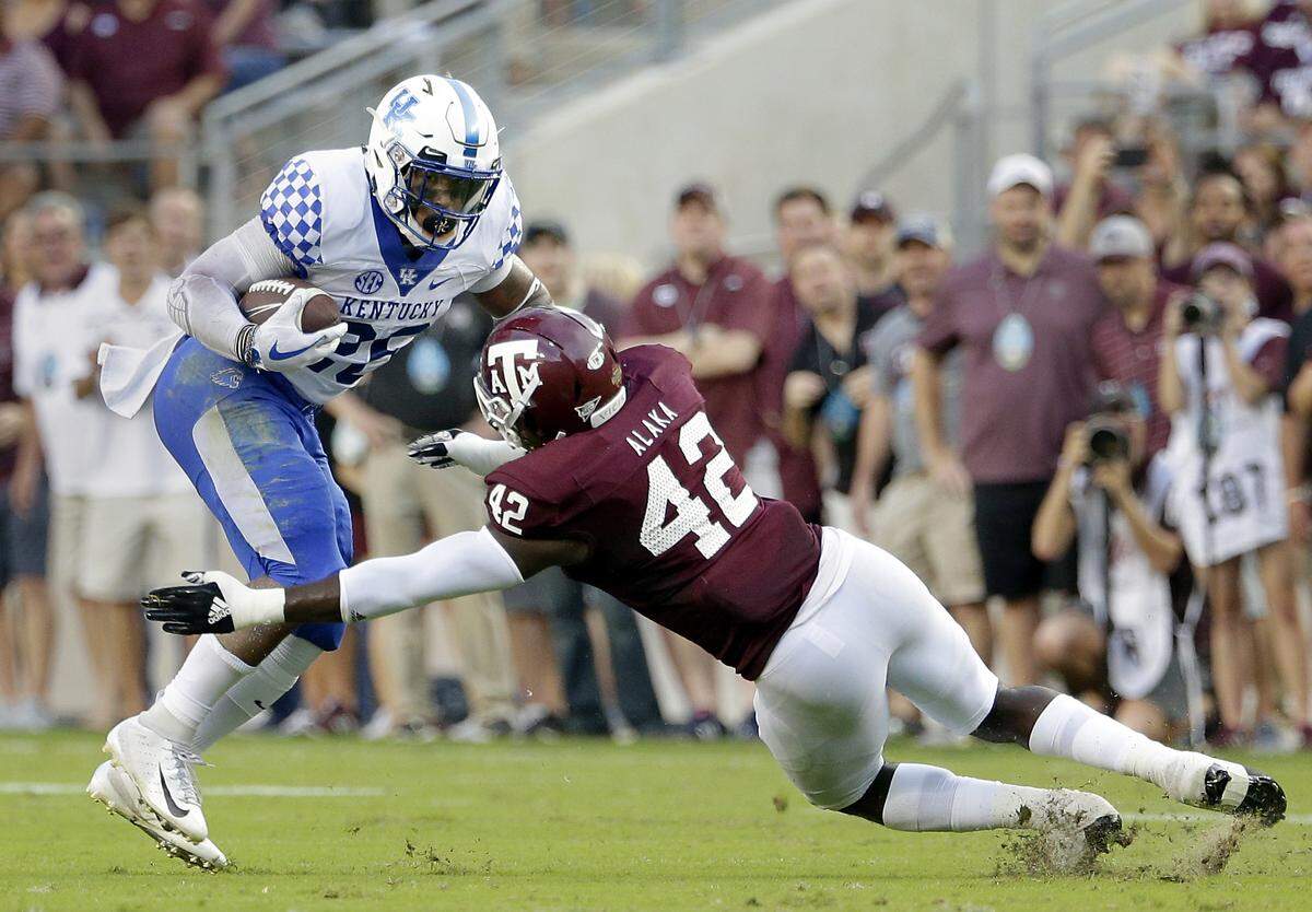 Kentucky running back Benny Snell was tackled by Texas A&M linebacker Otaro Alaka during UK’s 20-14 overtime loss to the Aggies last season.