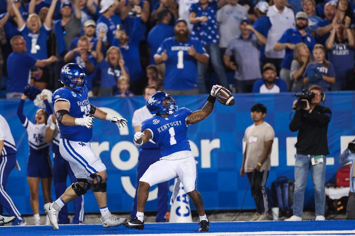 Kentucky running back Ray Davis (1) celebrates a touchdown against Akron during Saturday’s game at Kroger Field.