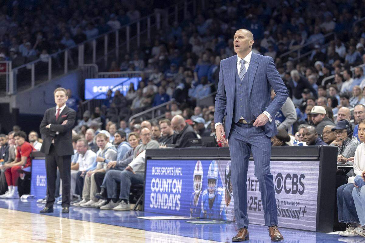 Kentucky basketball coach Mark Pope, right, watches his team play against St. John’s during the CBS Sports Classic at State Farm Arena in Atlanta, Ga., on Saturday, Dec. 20, 2025.