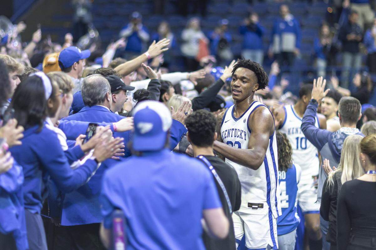 Kentucky center Amari Williams (22) celebrates with fans following Tuesday’s win against Tennessee at Rupp Arena.
