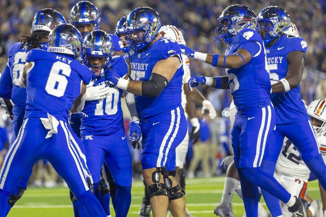 Kentucky redshirt running back Jamarion Wilcox (10) was congratulated by teammates after scoring his first college touchdown during UK’s 24-10 loss to Auburn at Kroger Field last week.