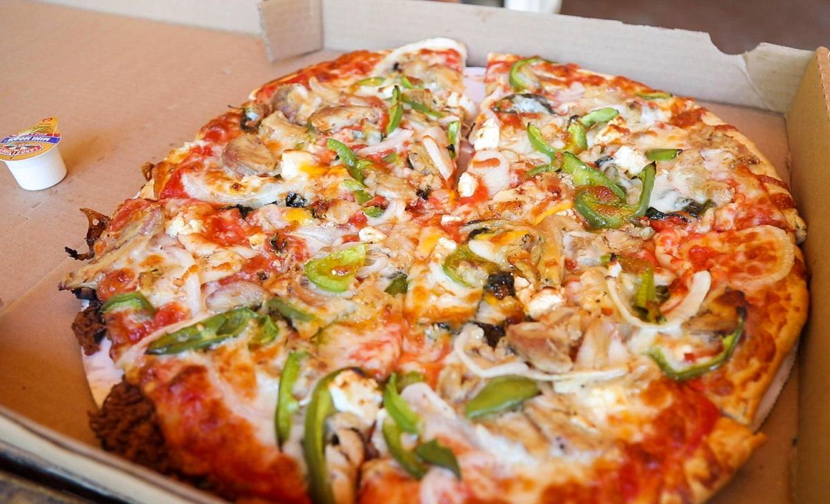 A customized pizza from Miguel’s with vegetables and chicken in Slade. Miguel’s Pizza offers pizza with choices from 50 different fresh toppings and even gluten and dairy free options.