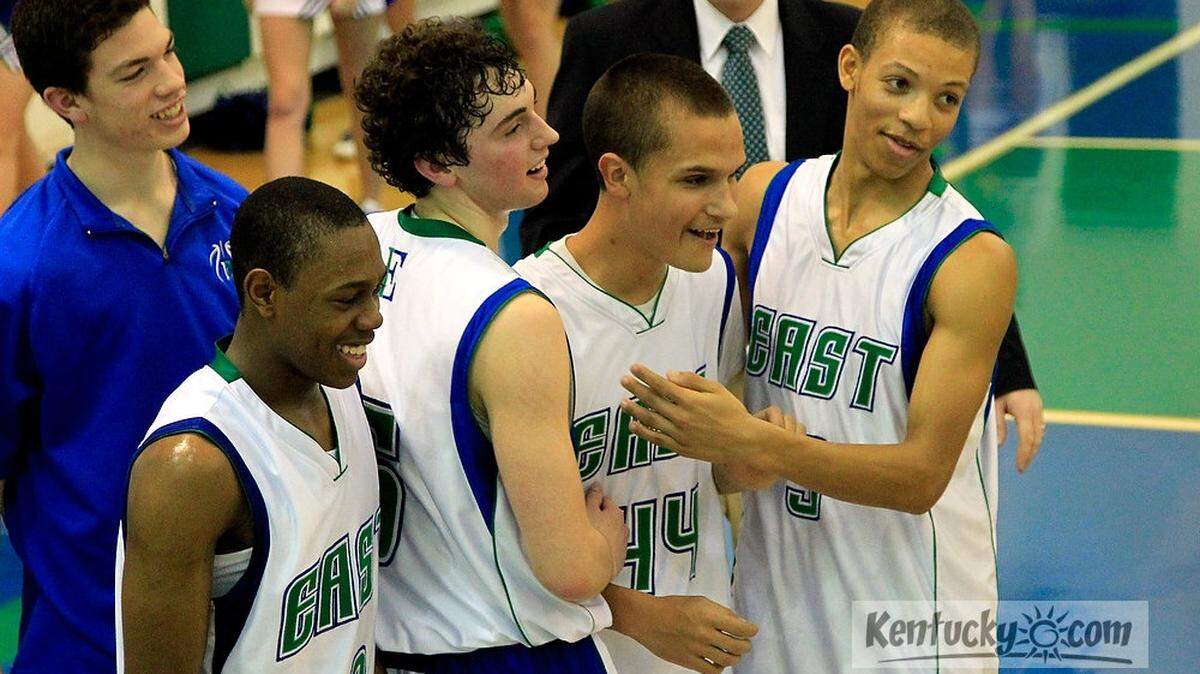 Players congratulated East Jessamine's Kevin Courtney (44) after a 89-68 win over Model in Nicholasville, Ky., on Feb. 16, 2012. Photo by Pablo Alcala | Staff