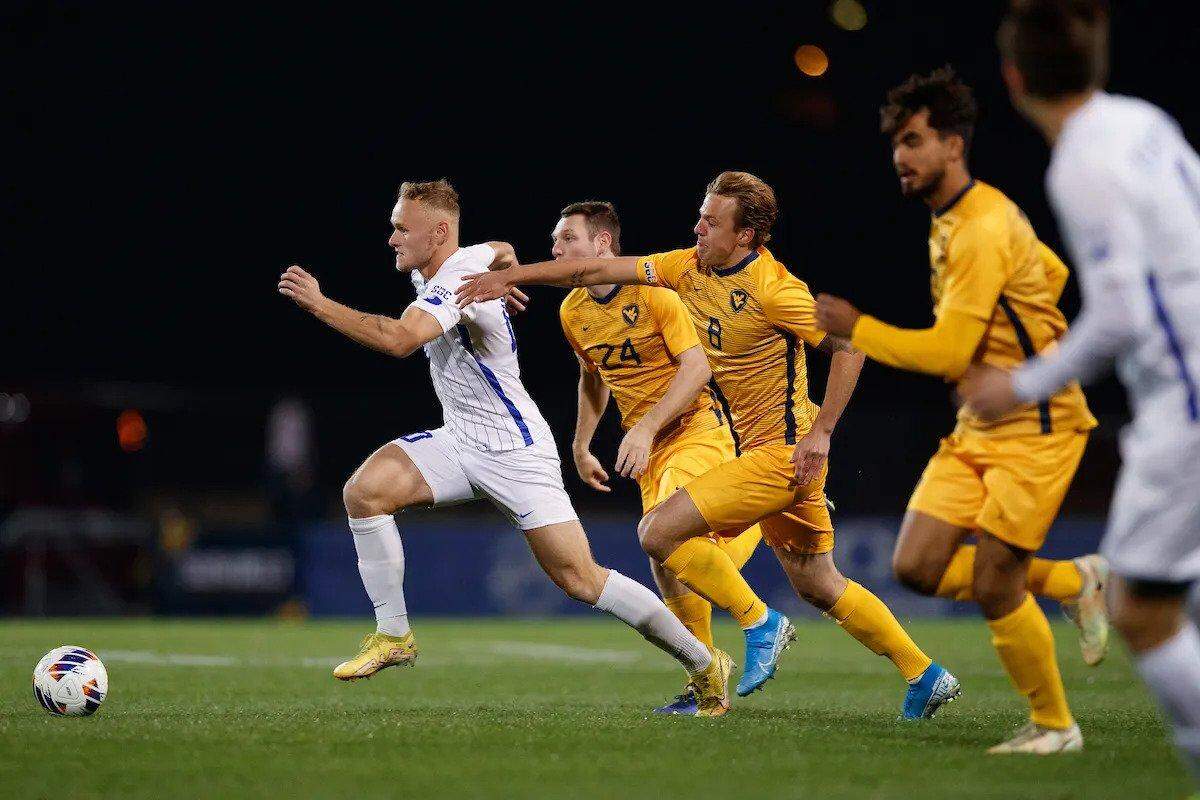 Kentucky’s Casper Grening races a trio of West Virginia defenders to the ball at UK’s Bell Soccer Complex during last week’s Sun Belt Conference Tournament.