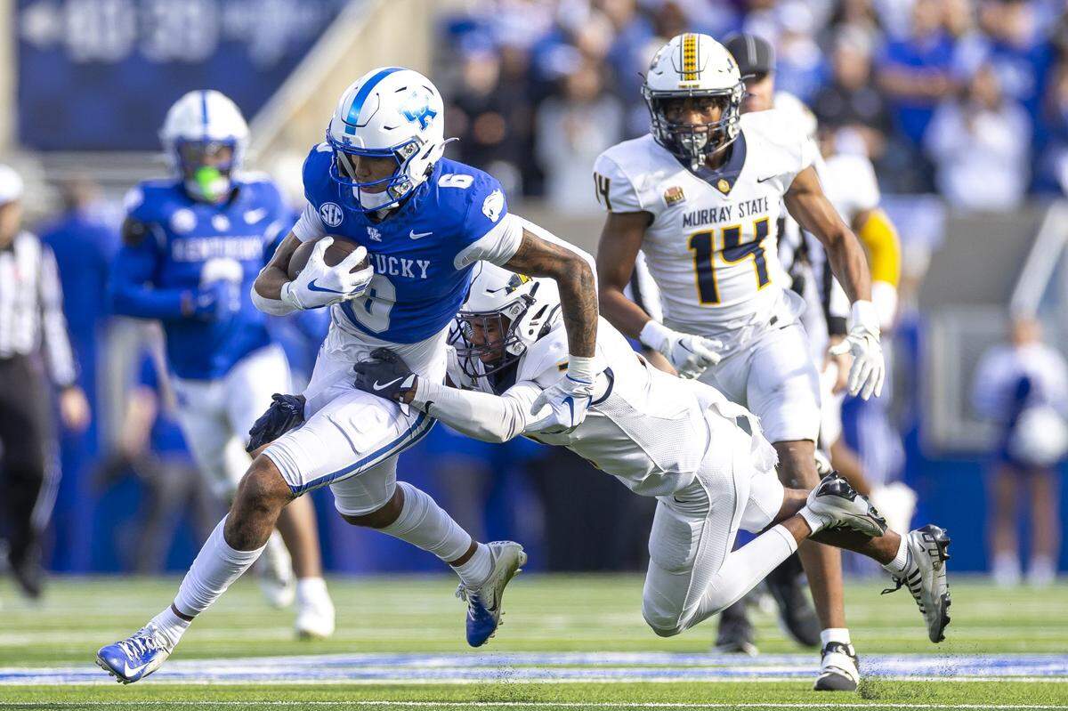 Kentucky wide receiver Dane Key (6) tries to elude Murray State’s Larry Preston during Saturday’s game at Kroger Field. Key caught three passes for 56 yards.