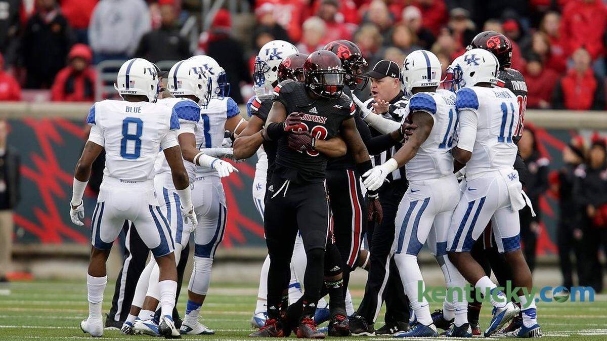 Players were pulled away from each other in the third quarter of the Kentucky at Louisville football game at Papa John's Cardinal Stadium in Louisville, Ky., on Nov. 29, 2014. Louisville won 44-40. Photo by Pablo Alcala | Staff