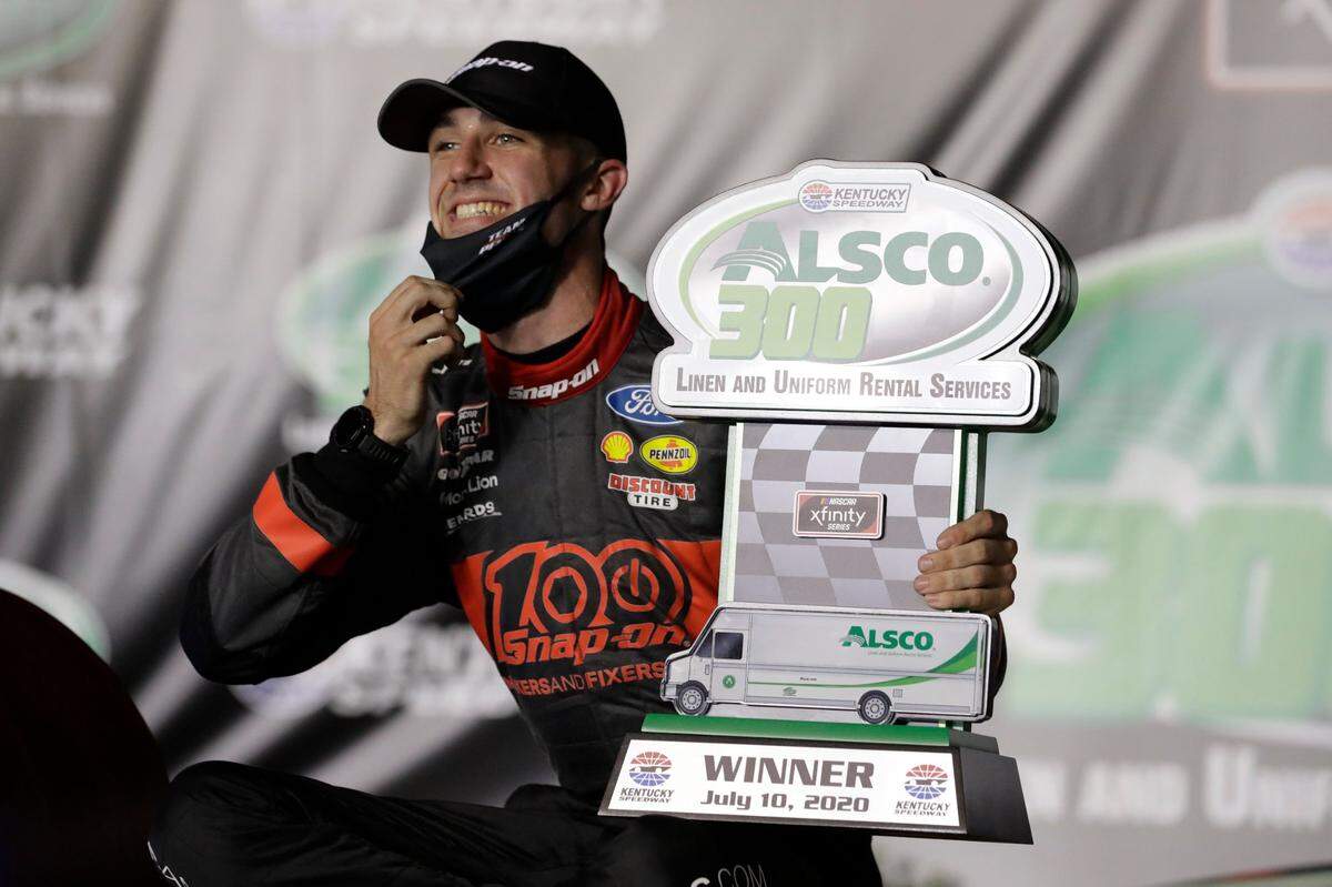 Austin Cindric (22) pulled down his face mask to smile after winning the second of two Xfinity Series races he claimed on back-to-back nights last week at Kentucky Speedway.
