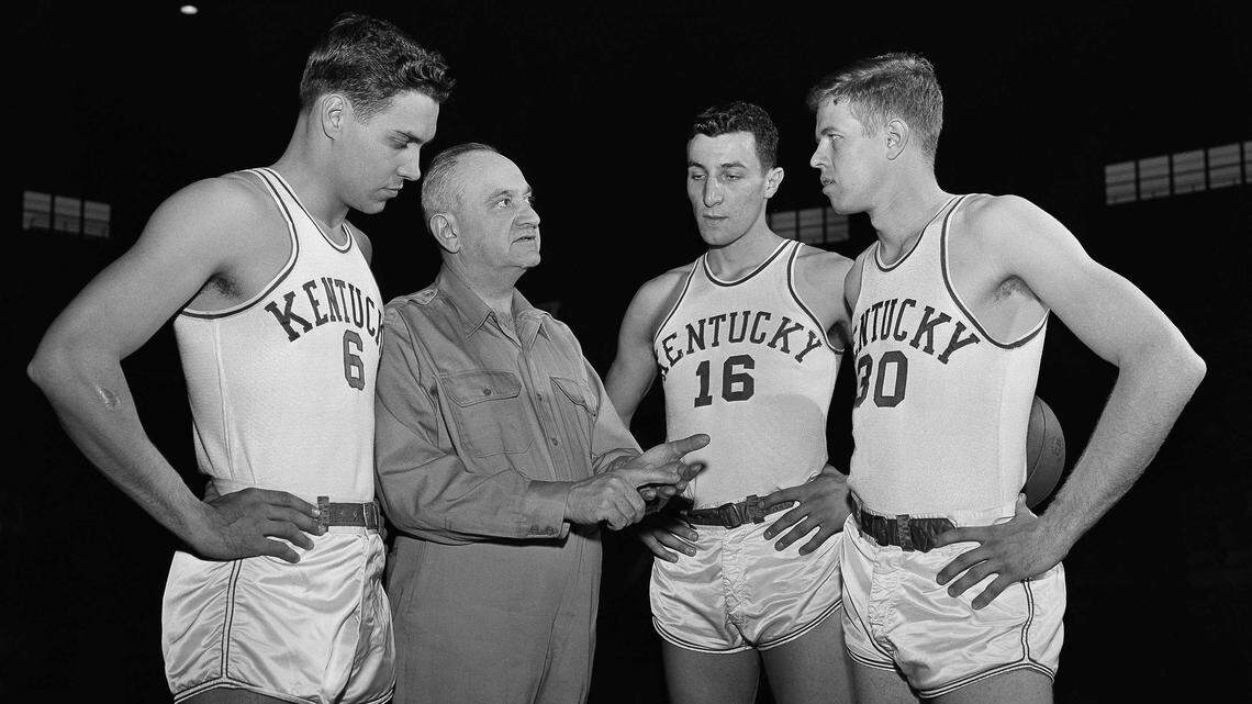 Frank Ramsey (30) posed for a photo with Coach Adolph Rupp and teammates Cliff Hagan (6) and Lou Tsioropoulos (16) on Jan. 16, 1954. The 1953-54 Wildcats, during Ramsey’s senior season, finished the year 25-0.