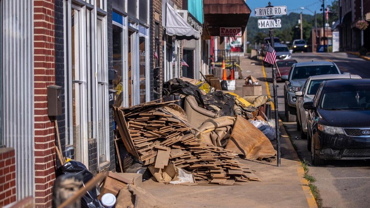 Furniture, carpet and wood damaged by flash flooding sit outside businesses in downtown Whitesburg, Ky., on Thursday, Aug. 4, 2022.