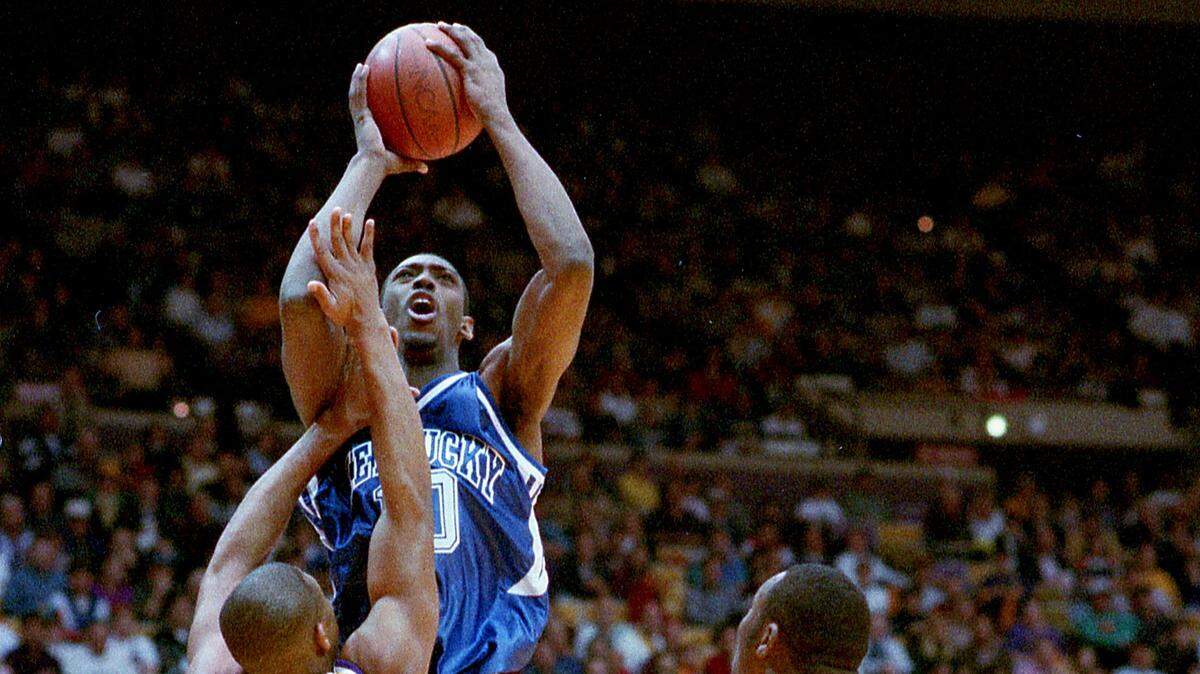 Kentucky’s Andre Riddick put up shot in front of Louisiana State’s Lenear Burns and Clarence Ceasar as UK rallied from 31 points down to defeat the LSU Tigers 99-95 at Baton Rouge, February 15, 1994. Photo by Tim Mueller/The Advocate.