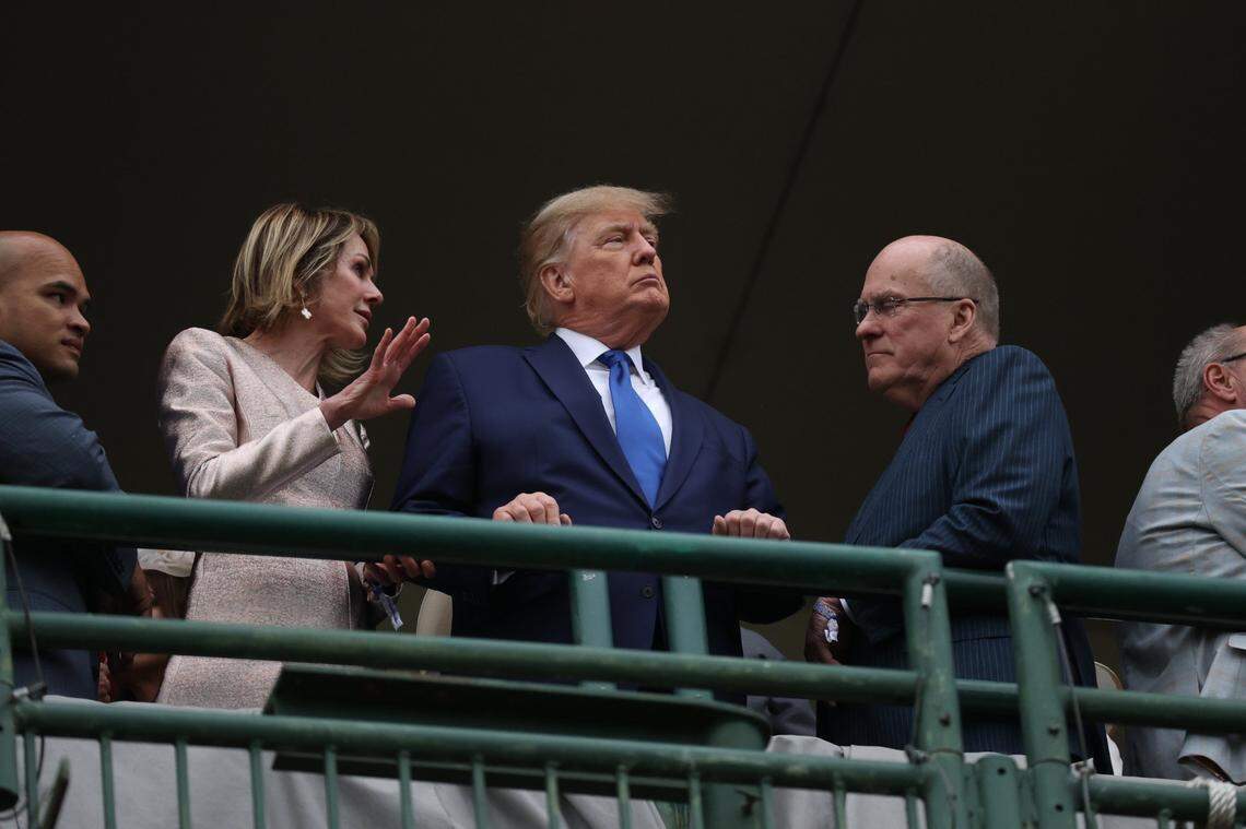 Kelly and Joe Craft stand on either side of former US President Donald Trump before the start of the 148th Kentucky Derby at Churchill Downs in Louisville, Ky., Saturday, May 7, 2022.