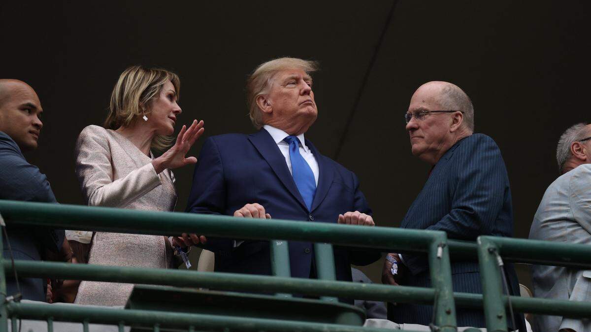Kelly and Joe Craft stand on either side of former US President Donald Trump before the start of the 148th Kentucky Derby at Churchill Downs in Louisville, Ky., Saturday, May 7, 2022.