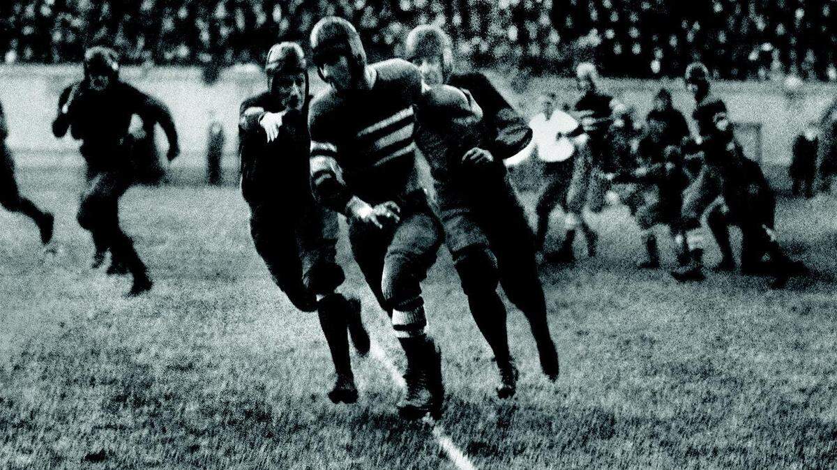 Quarterback Bo McMillin eluded two Harvard defenders on the way to scoring the only touchdown in Centre College's historic 1921 victory over Harvard, then a national football powerhouse.  