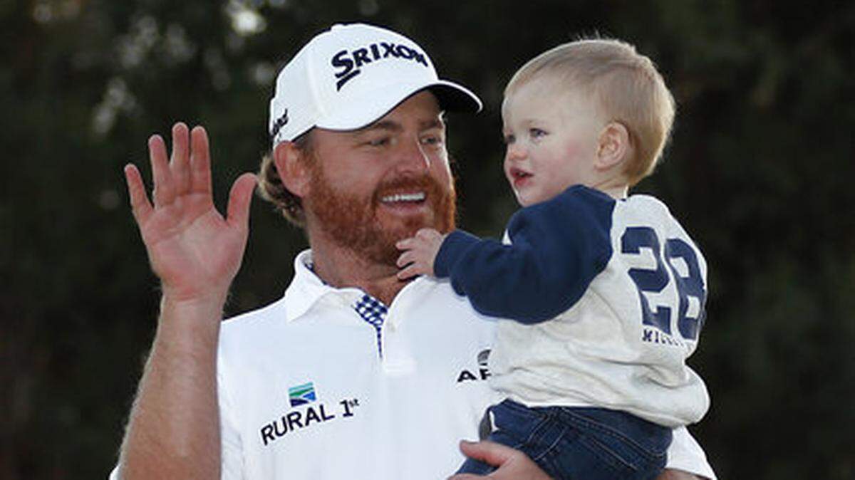 J.B. Holmes celebrates with his son, Tucker Bradley, on the 18th green after winning the Genesis Open golf tournament at Riviera Country Club on Sunday, Feb. 17, 2019, in the Pacific Palisades area of Los Angeles. (AP Photo/Ryan Kang)