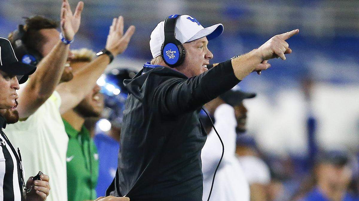 Kentucky head coach Mark Stoops shouted instructions to his team during Saturday night’s game against South Carolina at Kroger Field.