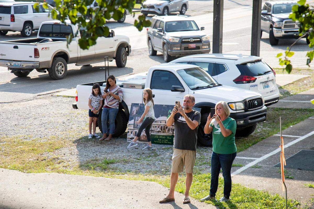 People stop to take photos and watch as the 17 foot four inch gooseÕs head was lifted and installed on the Mother Goose Inn in is replaced after collapsing from winter storms in Hazard, Ky., Friday, August 27, 2021.