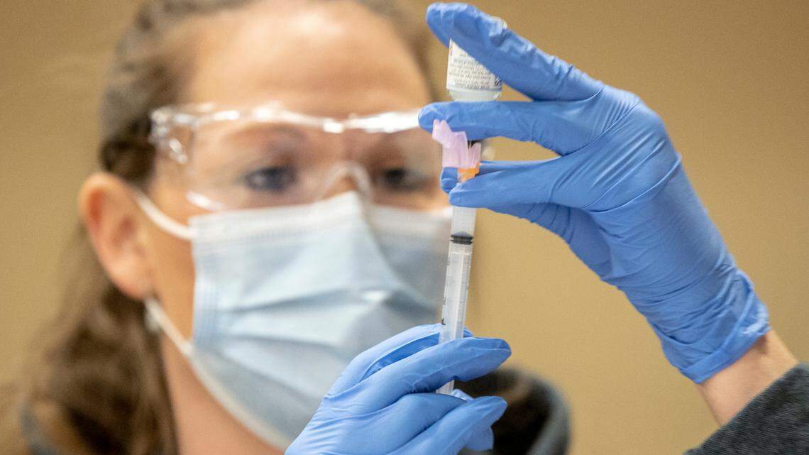 Kristen Parsons prepares a dose of the COVID-19 vaccine at a Lexington-Fayette County Health Department vaccination clinic at Consolidated Baptist Church in Lexington, Ky., on Wednesday, Feb. 3, 2021.