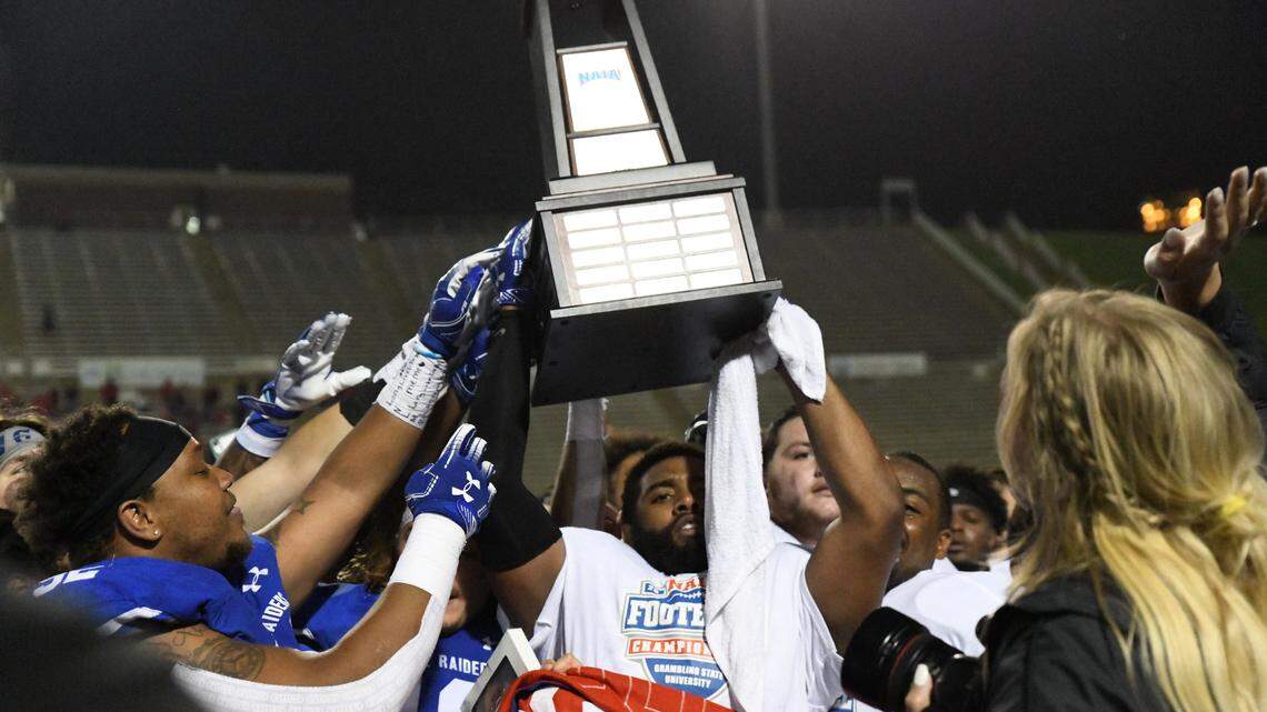 Lindsey Wilson College players hoisted the NAIA national championship trophy after the Blue Raiders walloped Northwestern College 45-13 on May 10 to claim the school’s first football national title.