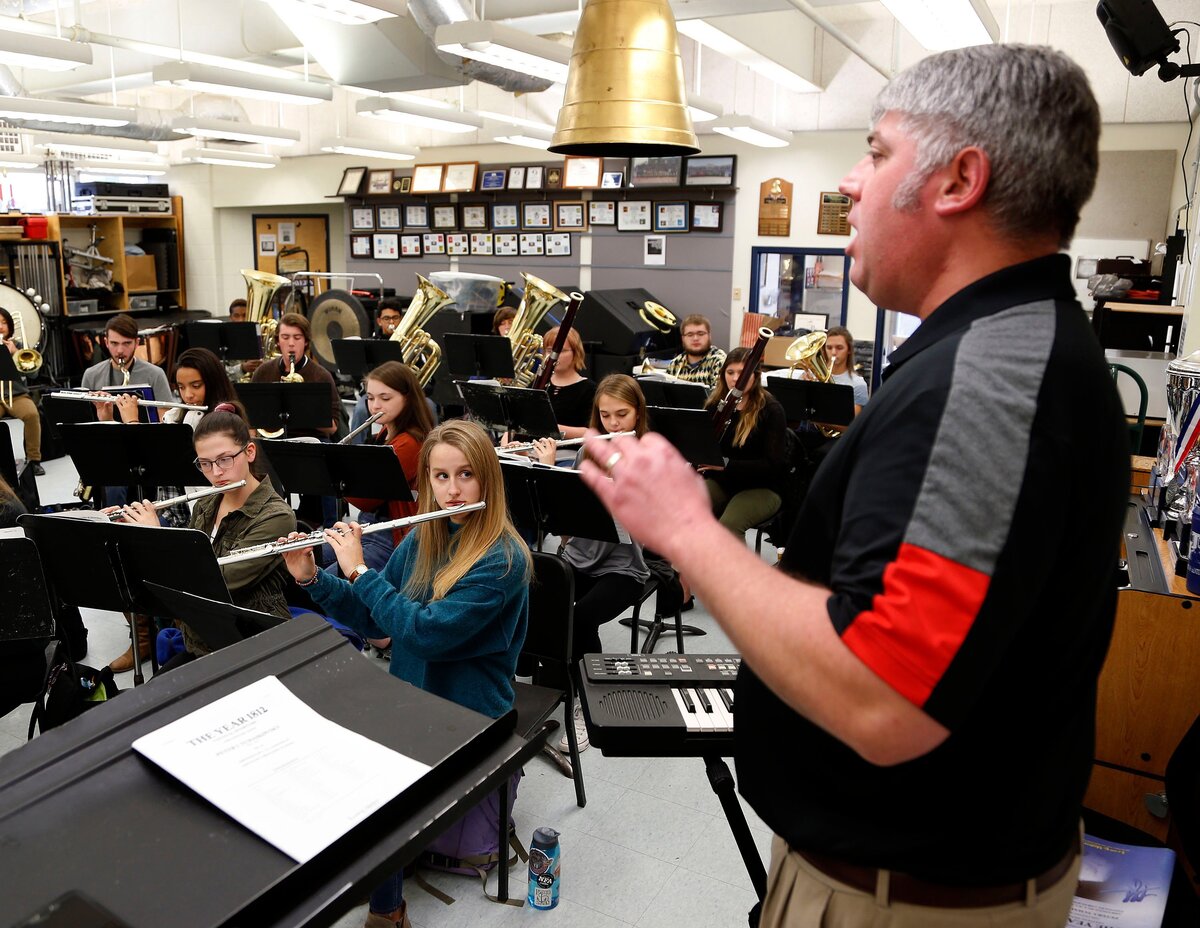 Henry Clay student Katie Demos, middle, looked at band director Bill Kite as she played her flute during a recent class at the high school in Lexington.