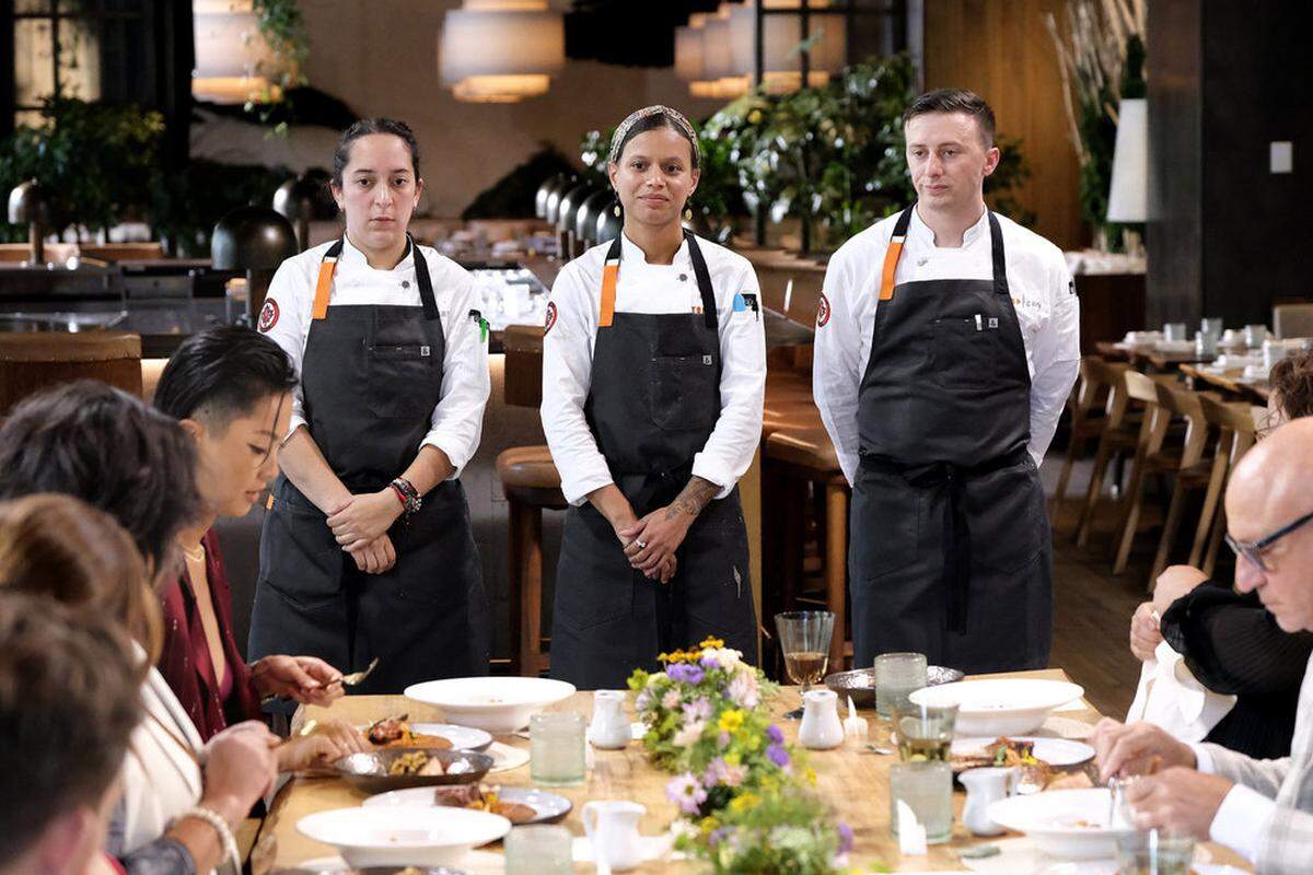 “Top Chef” contestants Paula Endara of Lexington, Lana Lagomarsini and Vincenzo Loseto appear before judges including Kristen Kish, left, and Tom Colicchio, right, on the first episode of Season 22.