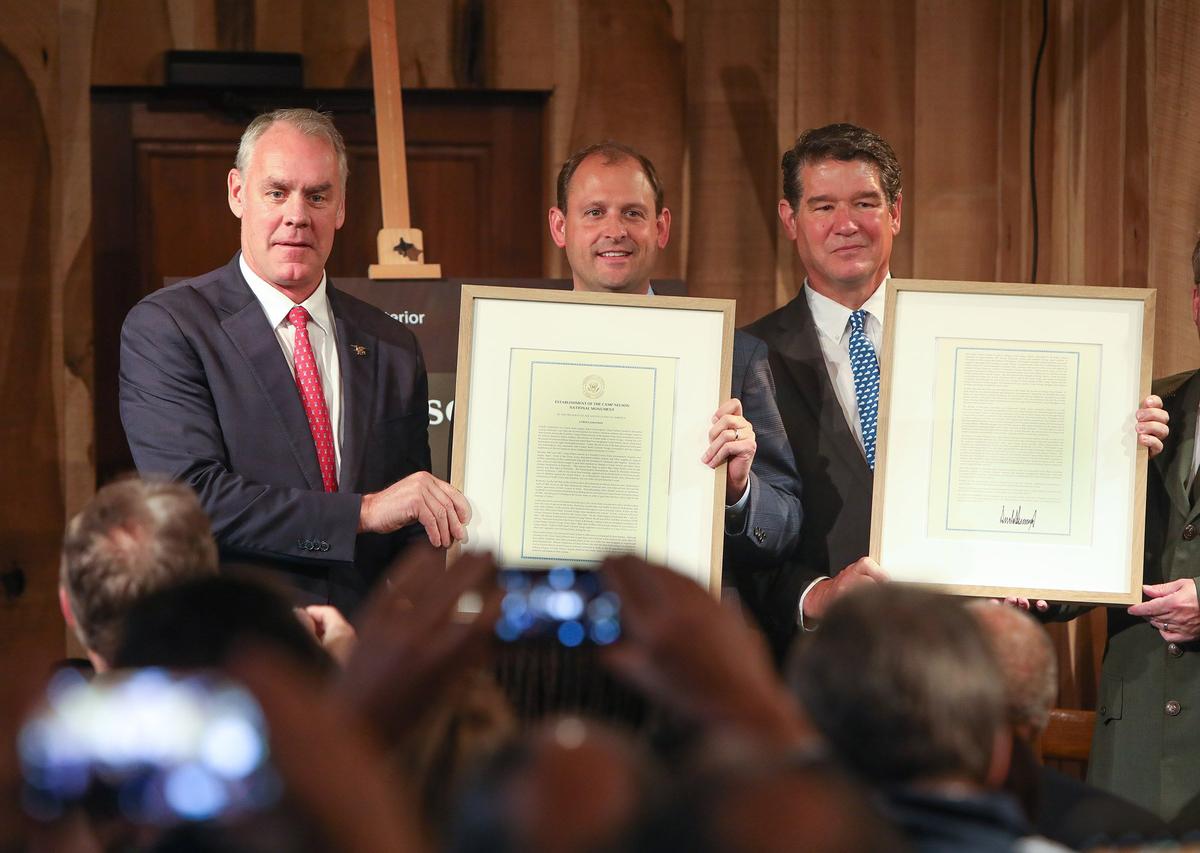 Interior Secretary Ryan Zinke, Rep. Andy Barr and Judge Executive David West held proclamations from President Trump declaring Camp Nelson a national monument Saturday.